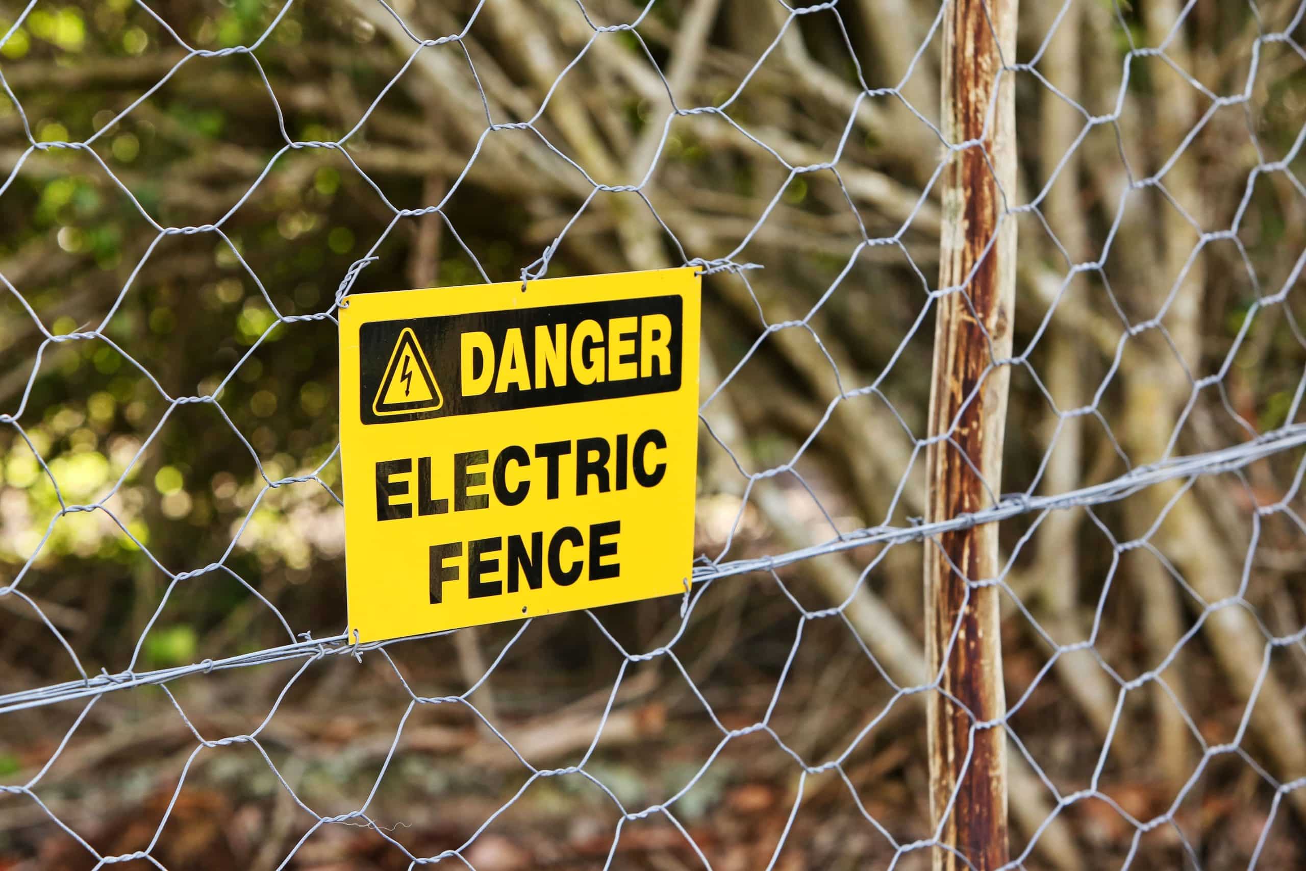 danger sign hung from electric fence 1 1